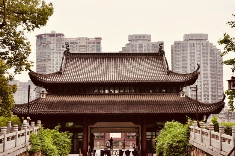 people in a temple surrounded by tall buildings