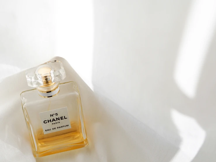 a bottle of chanel perfume on white cloth