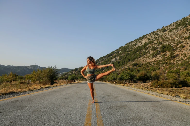 a woman standing on the side of the road