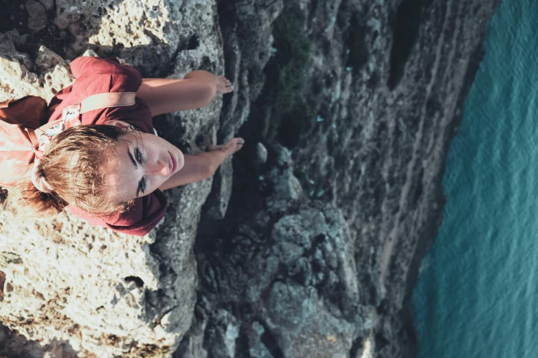 a boy who is climbing up a mountain