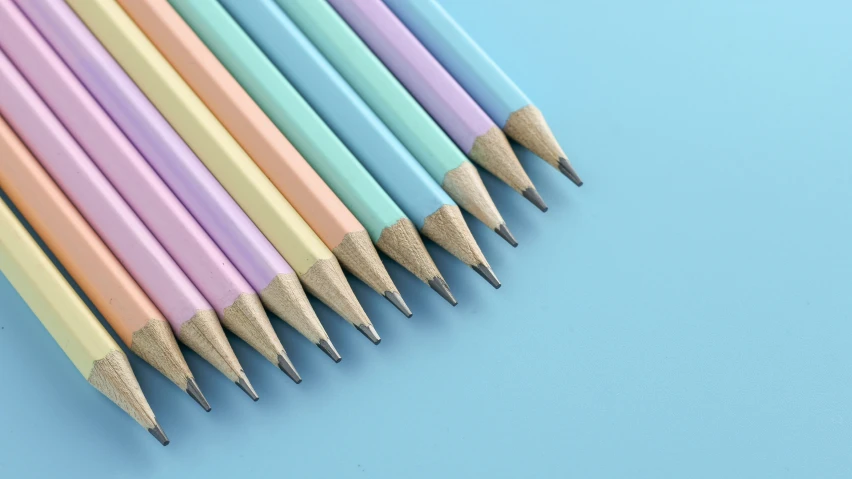 colorful pencils lined up on a blue background