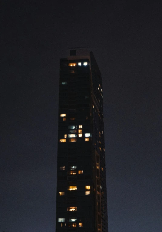 tall building with lights at night lit up the side of it