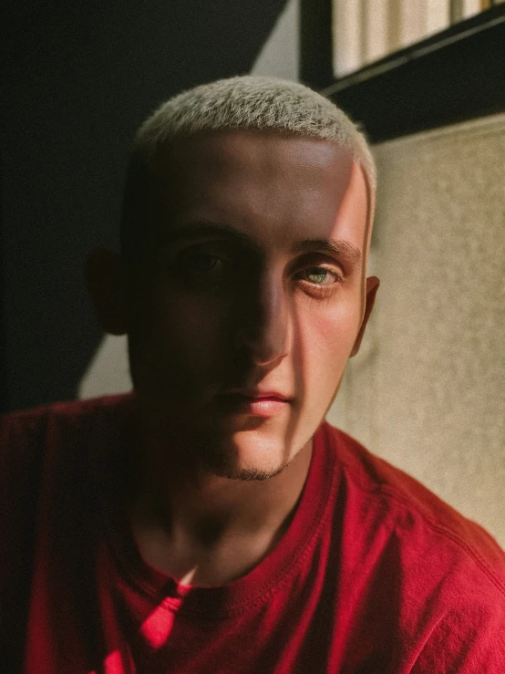 man looking at camera with light reflection behind him