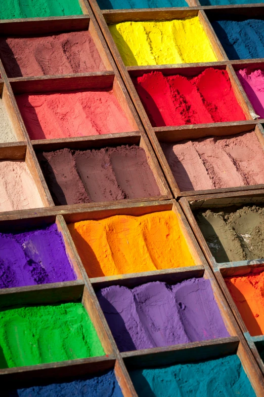 a number of trays of different colored pigment