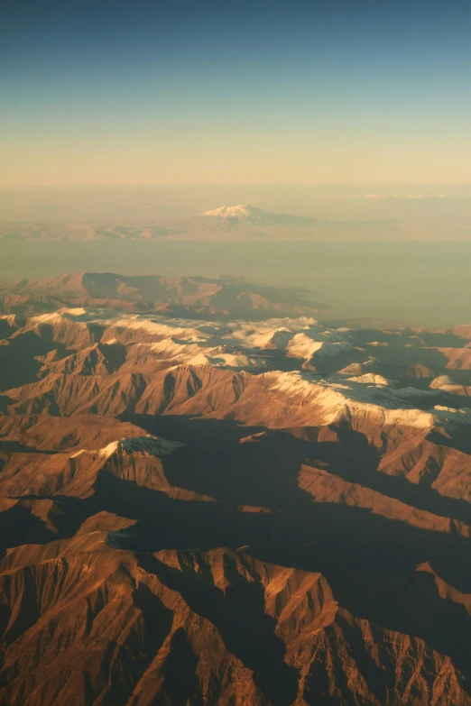 an aerial view of mountains in the distance