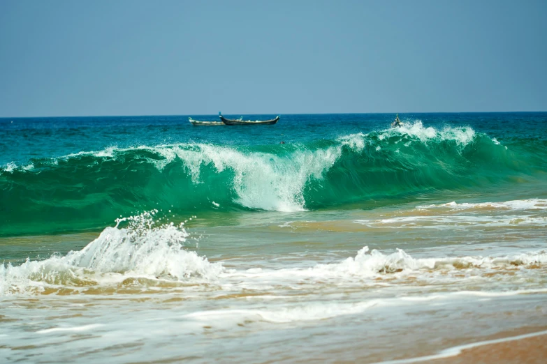 a boat in the ocean on top of an ocean wave