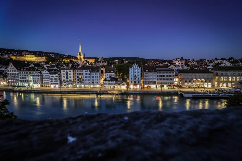 a city that has lights and buildings along side it