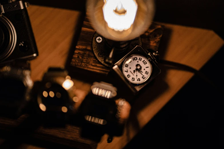 a couple of watches are sitting next to a camera