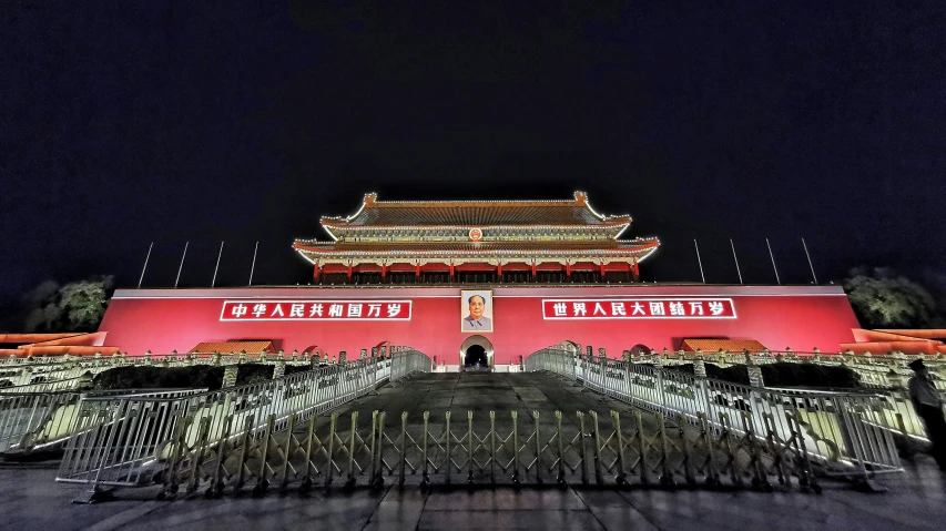 the chinese building is lit up and decorated in pink