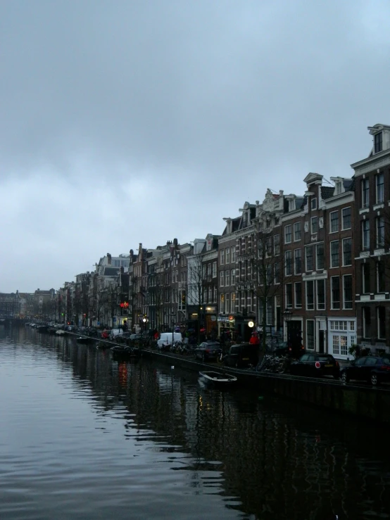 boats are on the water next to some buildings