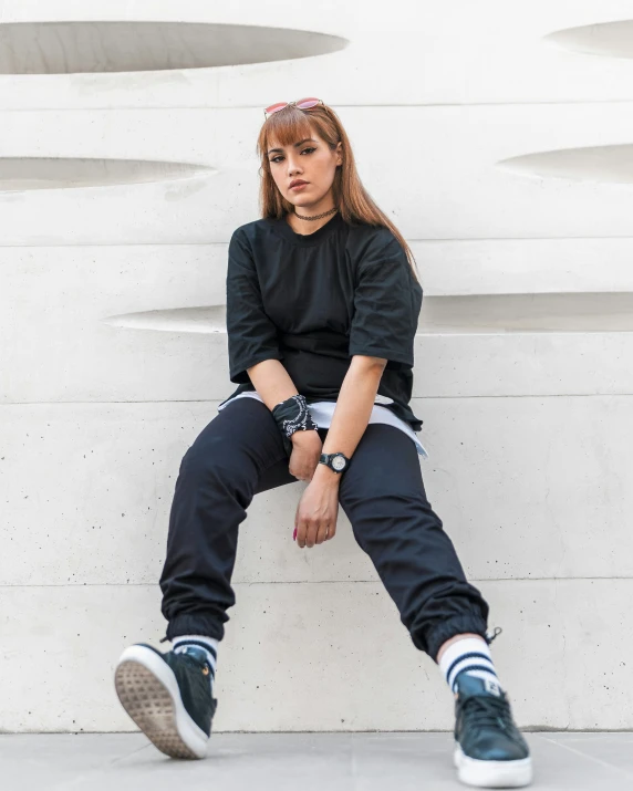 a girl sitting on top of some white stairs