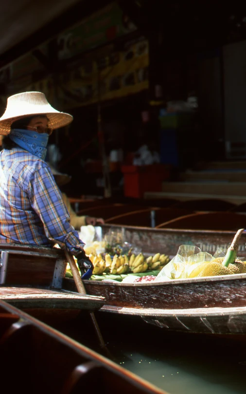 a man in a boat full of food on the water