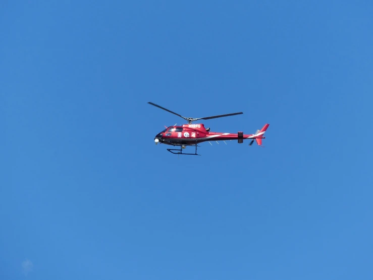 the helicopter is in the air while flying