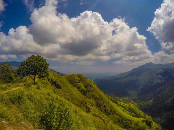 a person is walking uphill with a green hill in the background