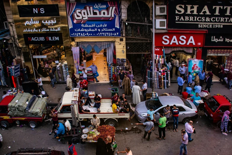 a street with people and cars and signs