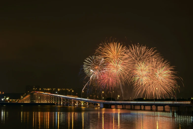 a bridge is lit up with colorful fireworks