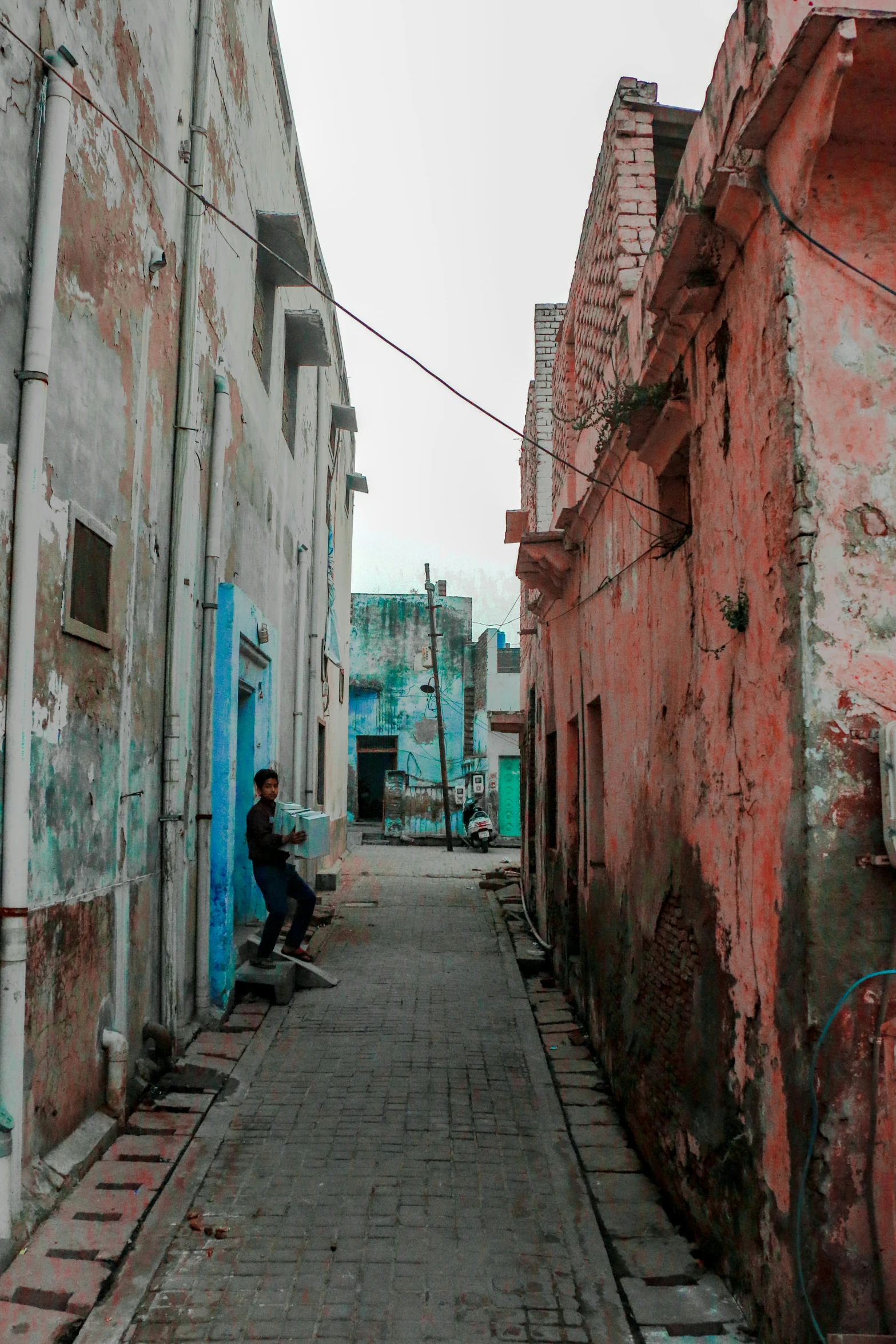 a narrow alley way with red brick buildings