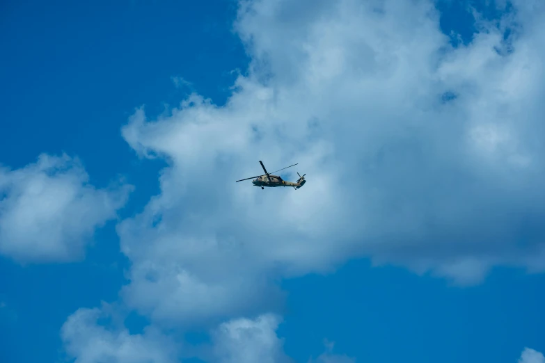 a plane is flying overhead in a partly cloudy sky