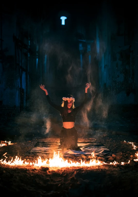 a woman standing in the fire in the dark