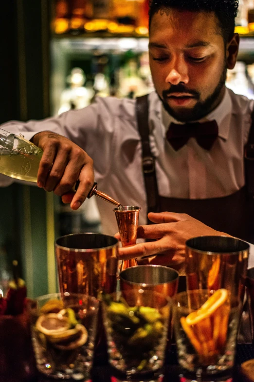 a man is pouring drink at a bar