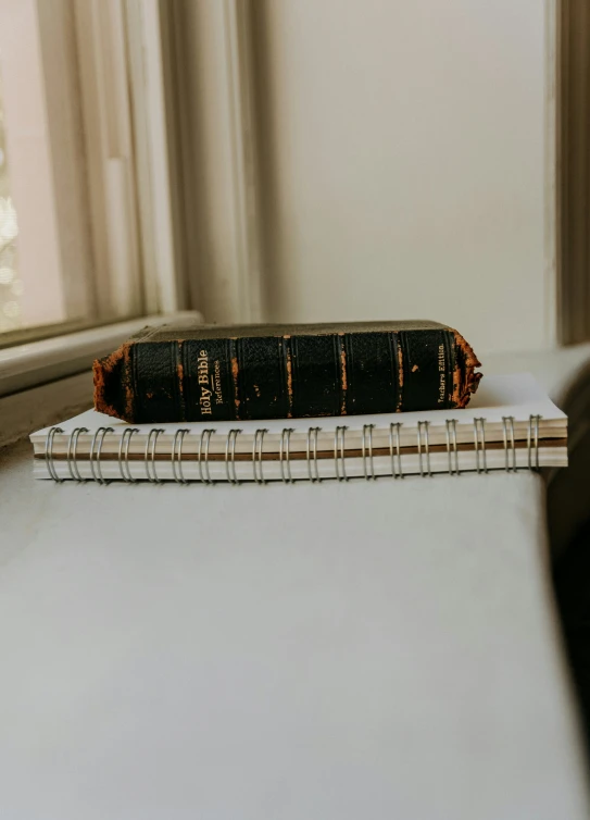 a books sitting on a table next to a window