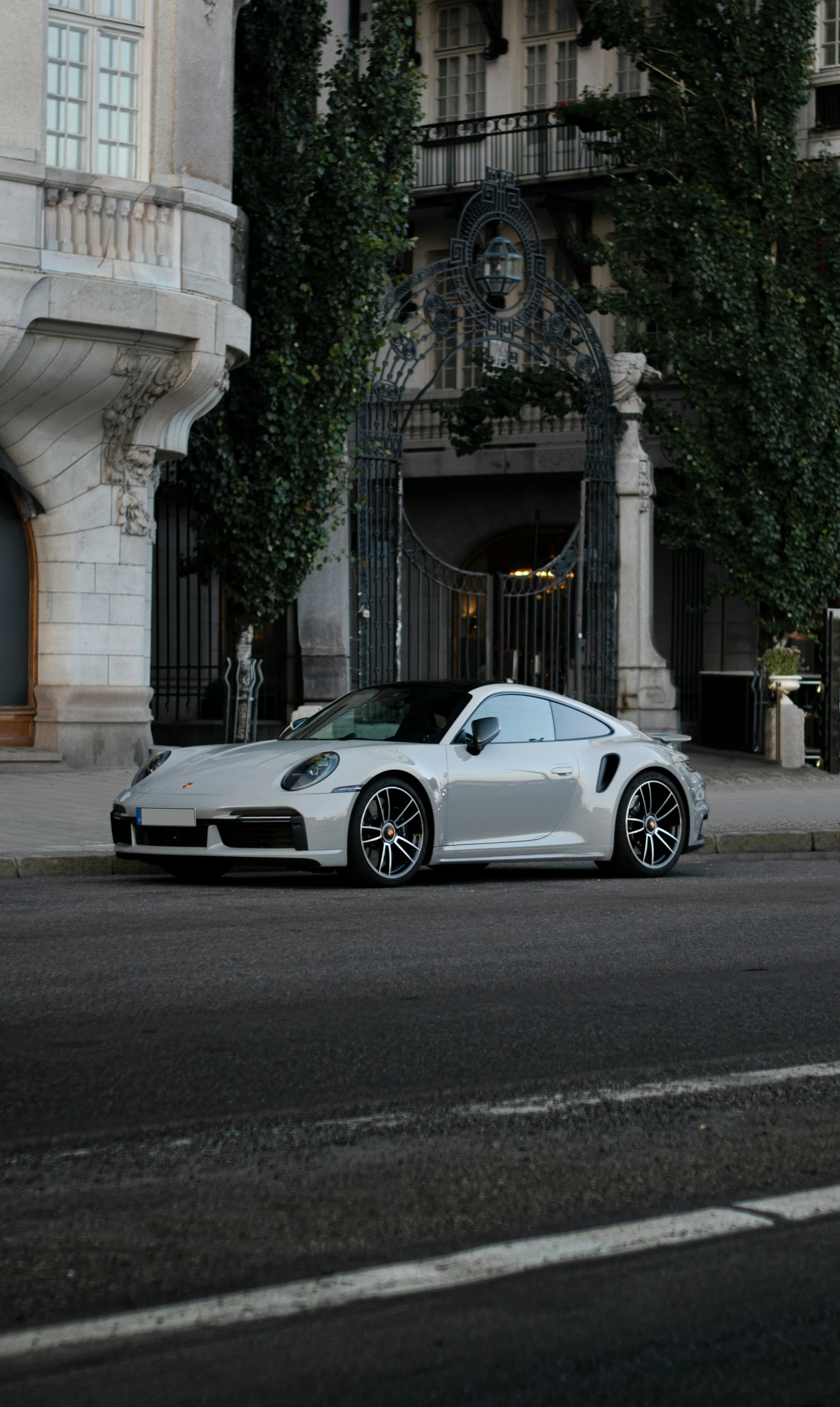 a white sports car parked outside a building