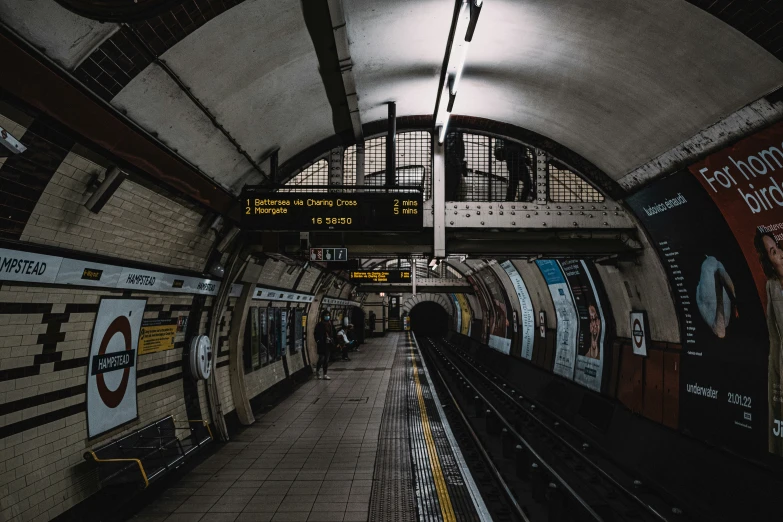 an underground railway station with several subway tracks