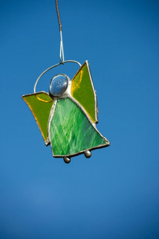 an ornament hanging on a pole decorated with colorful glass