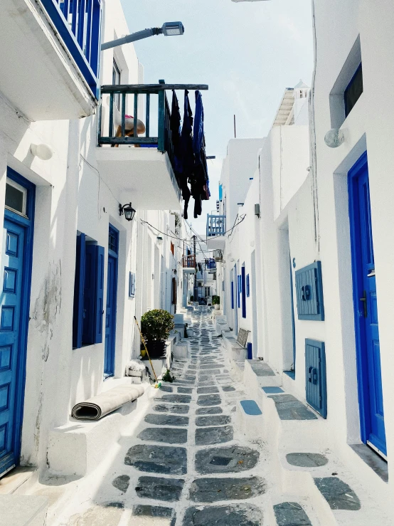 the narrow alley is made of whitewashed buildings