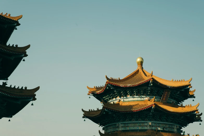 an airplane flying over a chinese pagoda that's golden