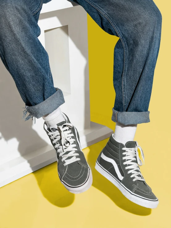 the person wearing black vans is on a yellow and white background