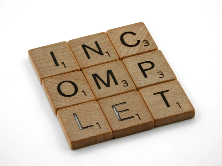 the words lndc omp let spelled in a letter made of scrabble wood blocks