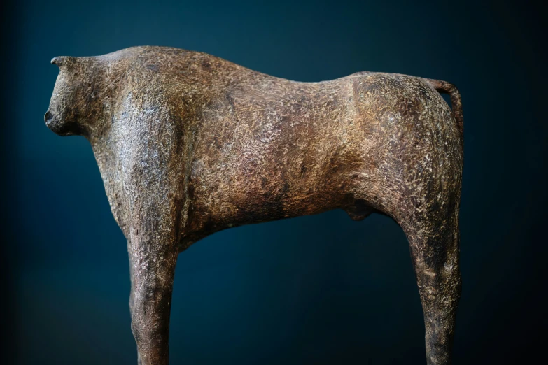 a bronze horse on a blue background