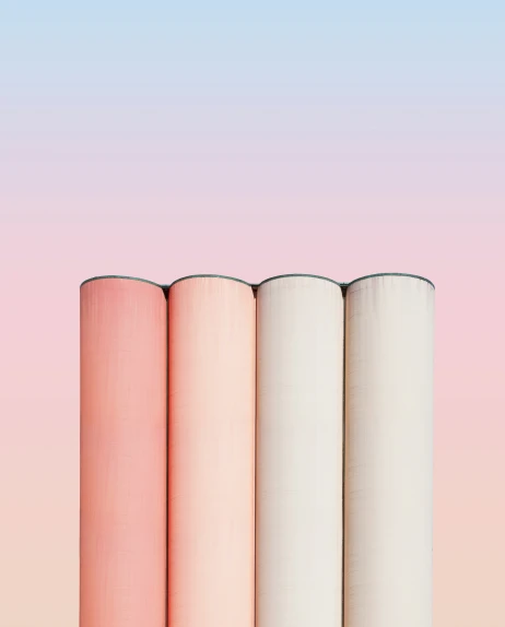 four cylindrical rolls of material lined up together