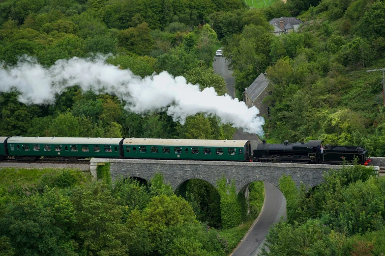 there is a train traveling on a bridge over the water