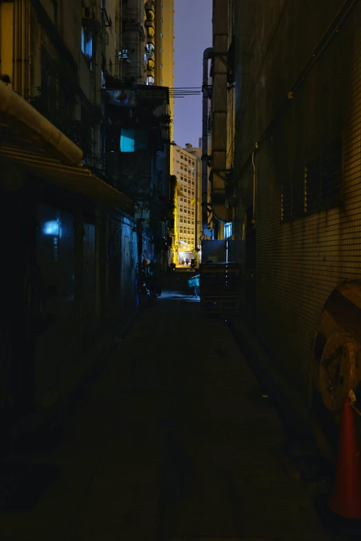 an alley between two tall buildings on either side