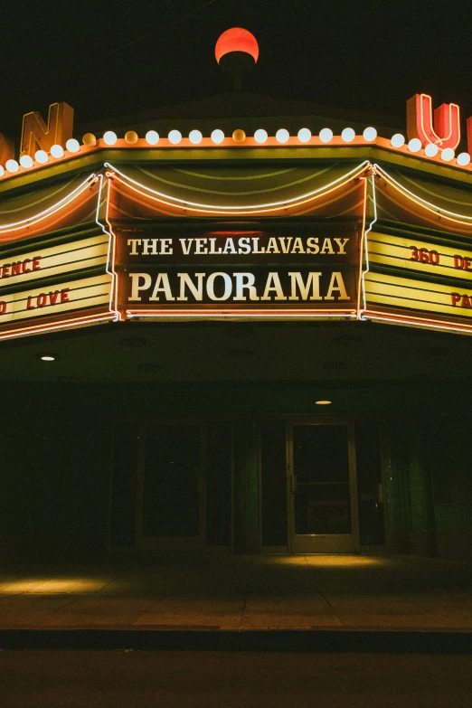 an ornate theatre that says the vegas awake and is decorated with lights