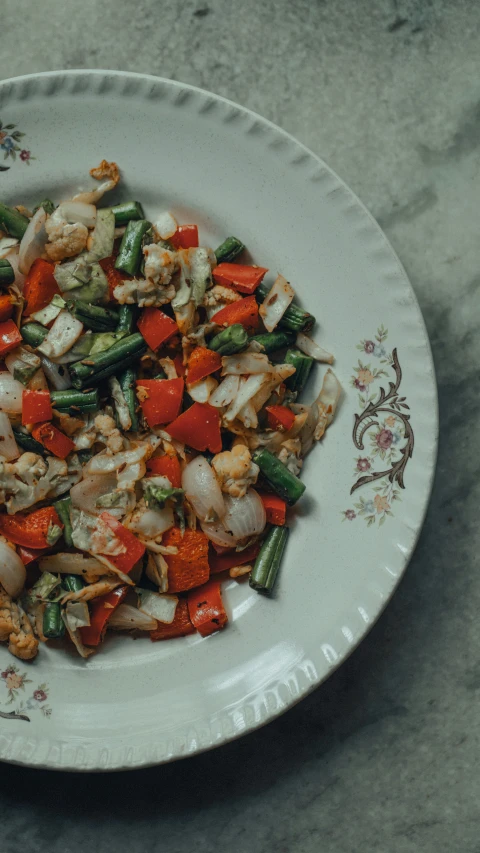 a plate of food containing onions, asparagus, carrots and onions