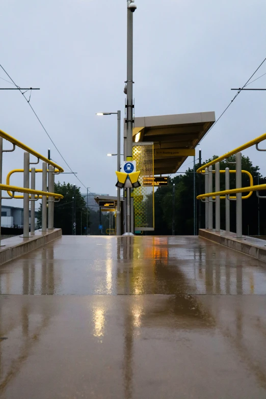 a rain soaked street filled with a couple of parking spaces