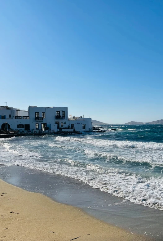 a row of houses on a beach near the ocean