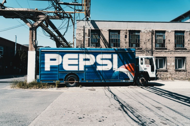 the pepsi truck is parked near a power line