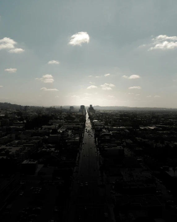 a city street lined with tall buildings under a cloudy sky