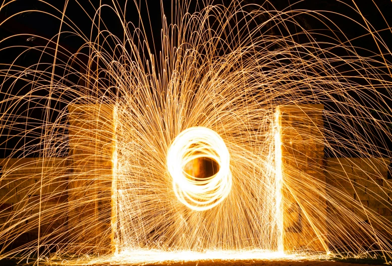 fireworks in the dark and a large black object with light in it