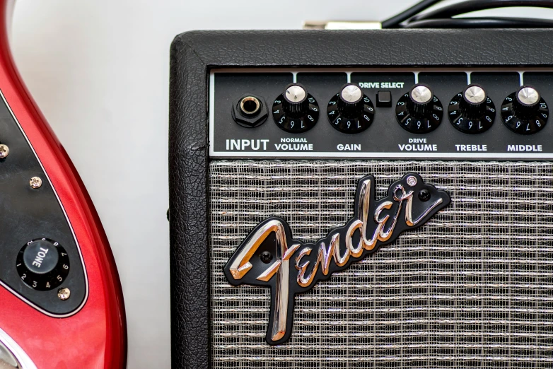 a red guitar amp next to a red guitar