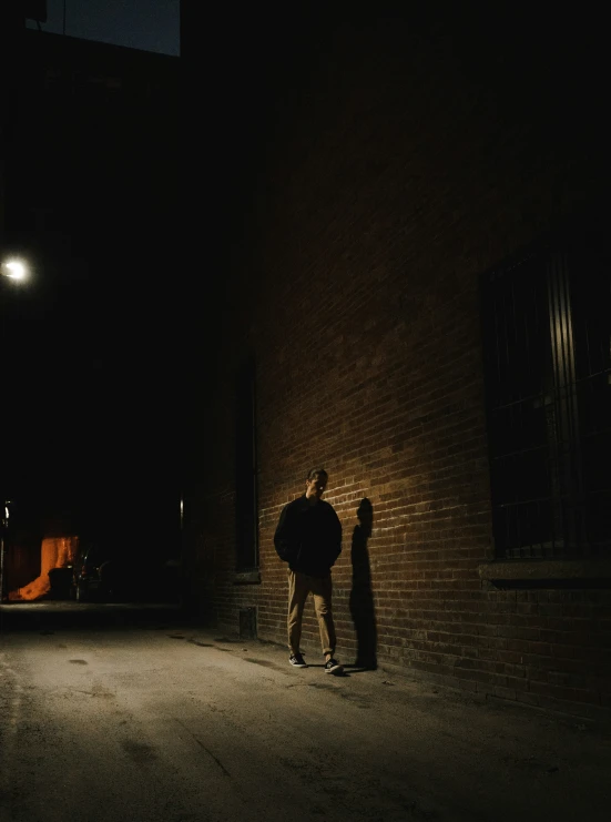 man holding onto an umbrella as he walks on the sidewalk