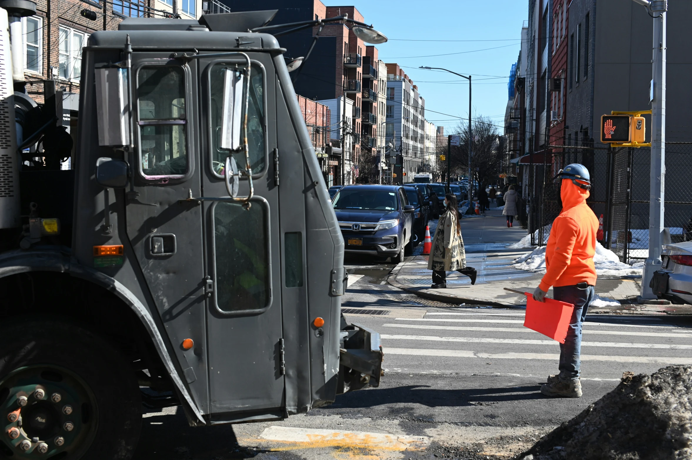 a worker directing traffic at an intersection in the city