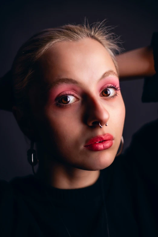 a girl with a piercing on her nose and pink eyes