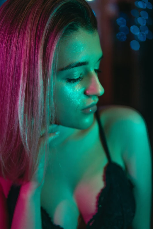 a beautiful woman in a black  top with a pink glow