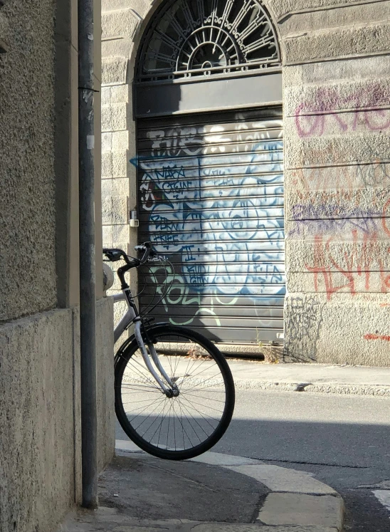 a bicycle leans against the side of a building