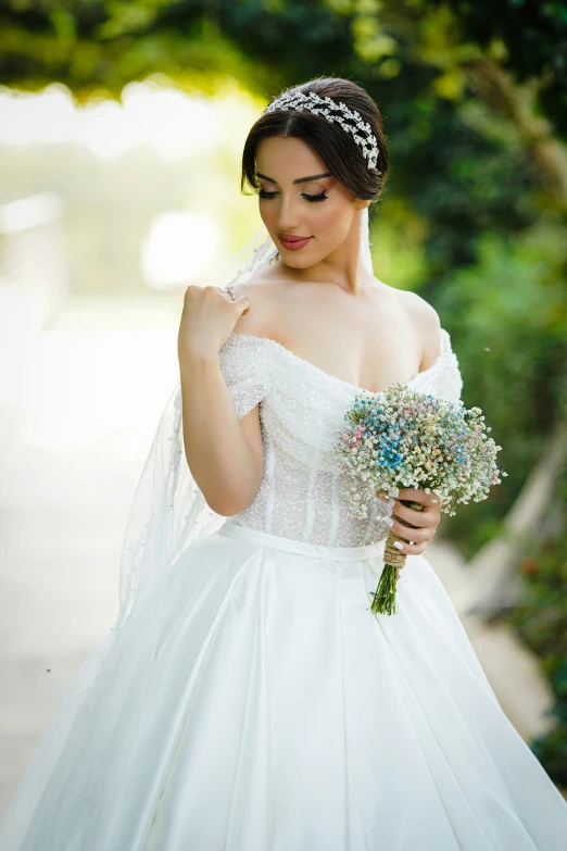 a bride holding a wedding bouquet of flowers